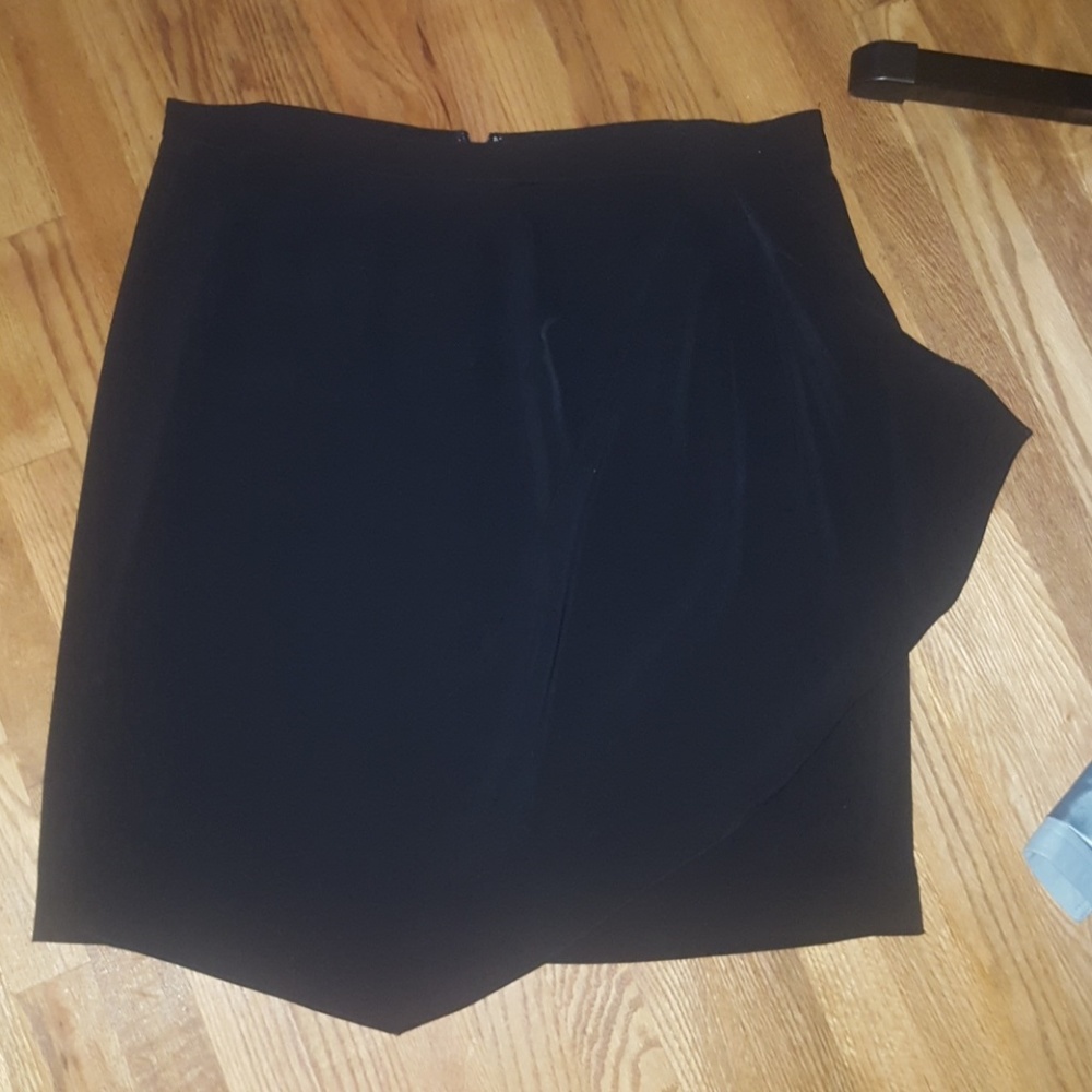 2 black knee length polyester skirts.